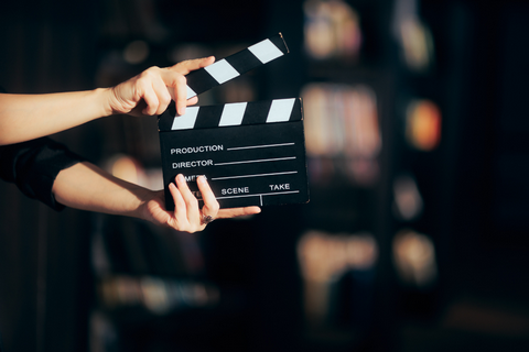 black and white movie starter being held in hands