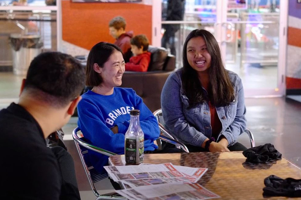 Chemistry grad students sit and talk at a table