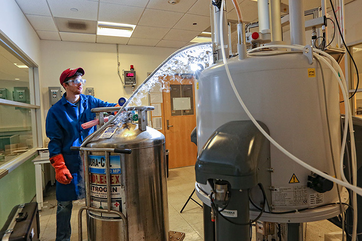A student works in the Brandeis University Nuclear Magnetic Resonance Facility