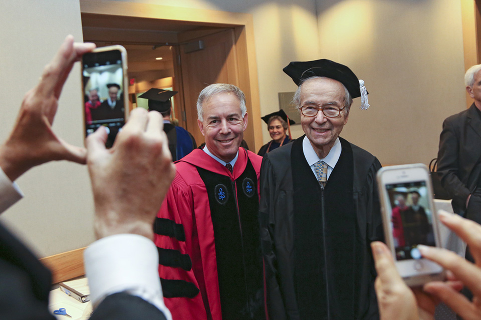 Frank Brandeis Gilbert makes his way to Commencement alongside Dan Terris.