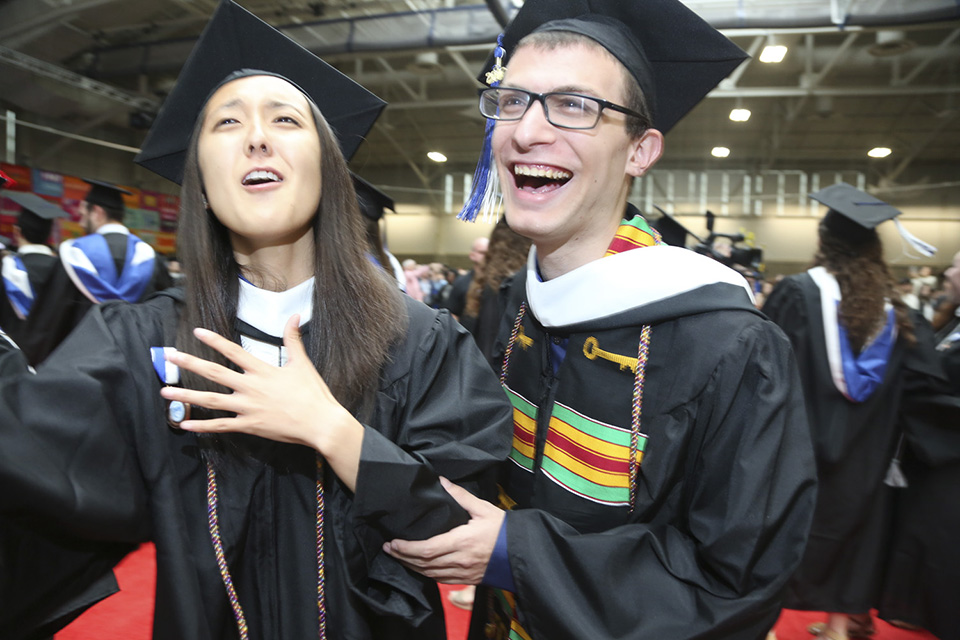 A lot of happiness, all at once: Two graduates with huge smiles