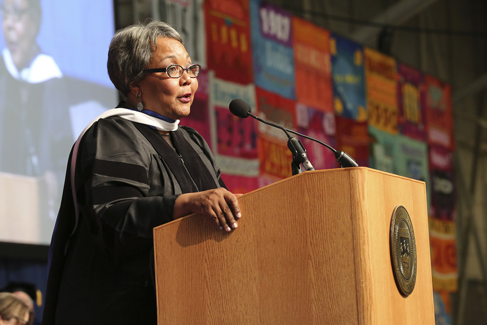 Julieanna Richardson '76, standing at the podium, offers wise advice to the graduates.