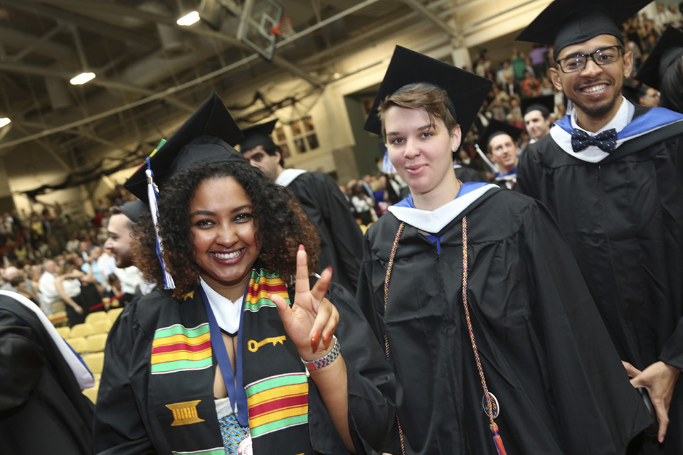 A jubilant hello on Commencement morning! Three graduates.