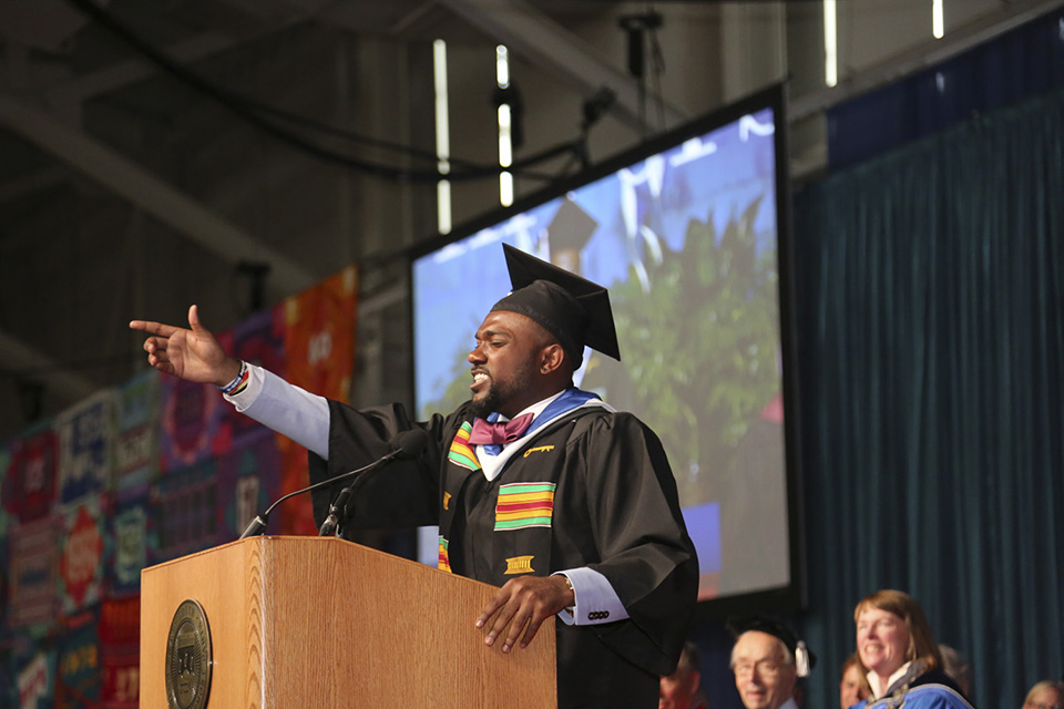 Joel Burt-Miller '16 delivers the student address, with arm outstretched.