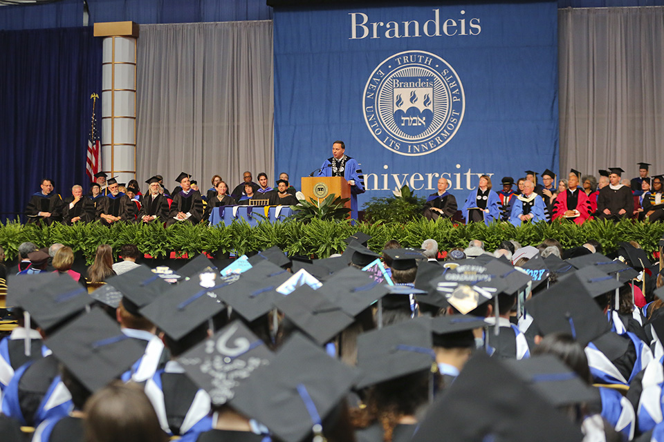 An ocean of mortarboards inside the Gosman Sports and Convocation Center as Brandeis President Ron Liebowitz speaks at the 66th Commencement Exercises. 
