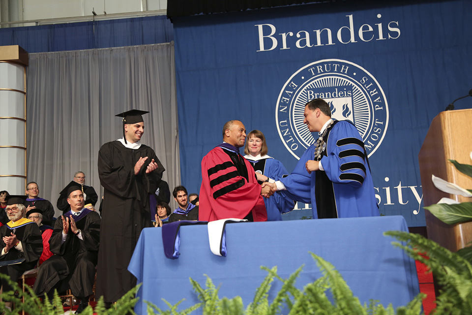 Former Massachusetts Governor Deval Patrick is awarded an honorary degree in law. Patrick is shaking hands with President Ron Leibowitz. From left to right: Ohad Elhelo '16, MA'17; former Gov. Patrick; Provost Lisa Lynch; President Ron Liebowitz 