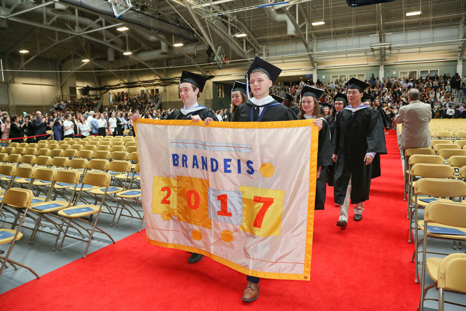 Graduates holding a banner that says 2017