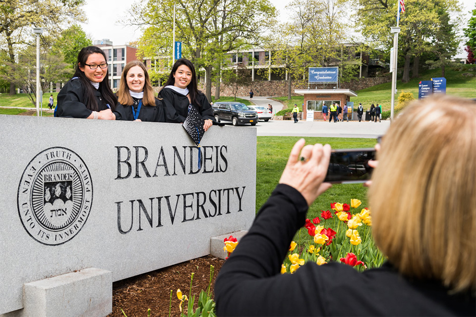 Graduates with the granite sign