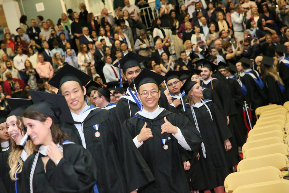 A student gives a thumbs up while filing in