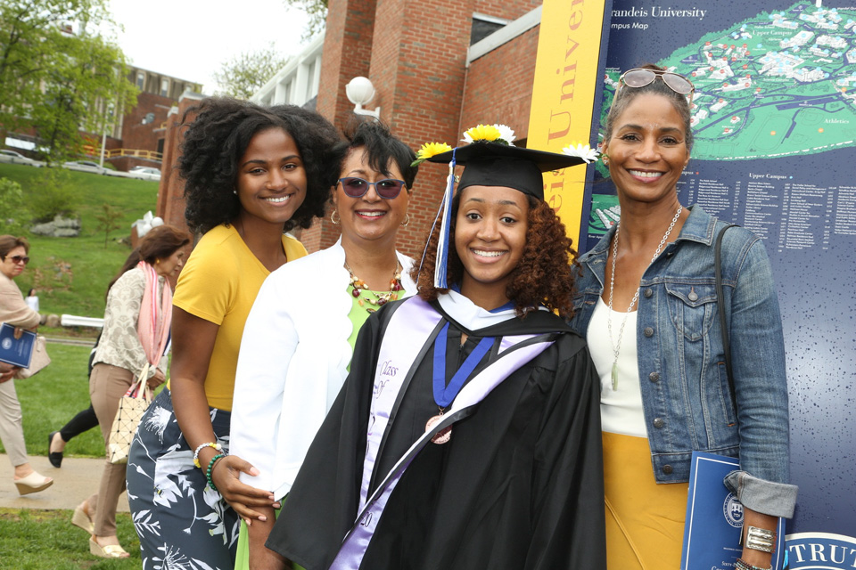 A graduate stands with her family