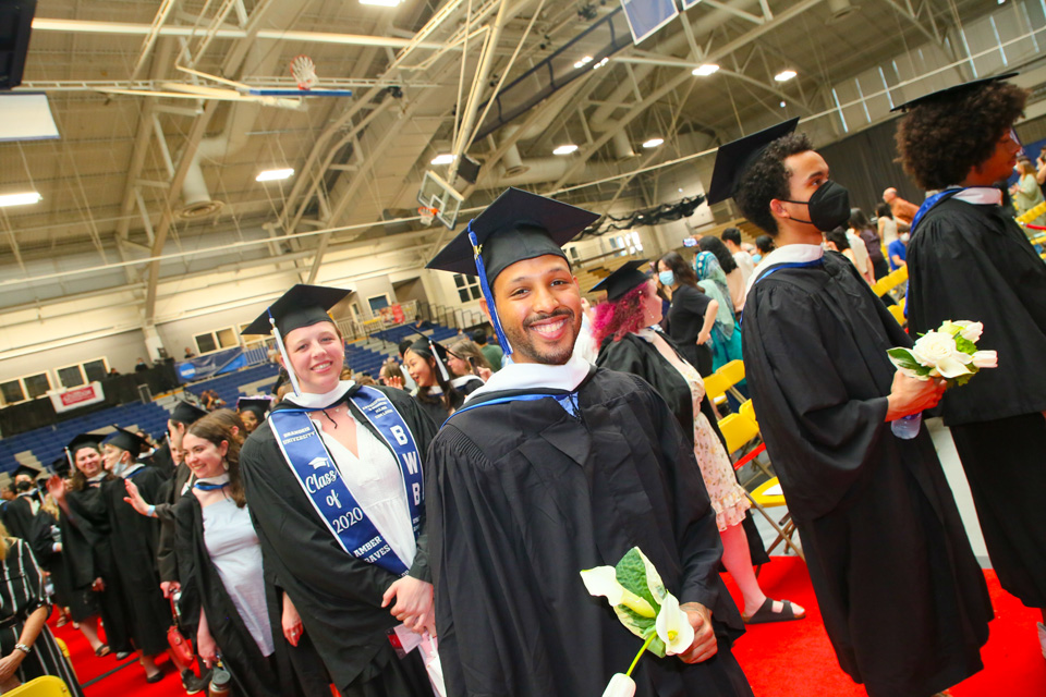 Class of 2020 and 2021 graduates entering Gosman for the ceremony