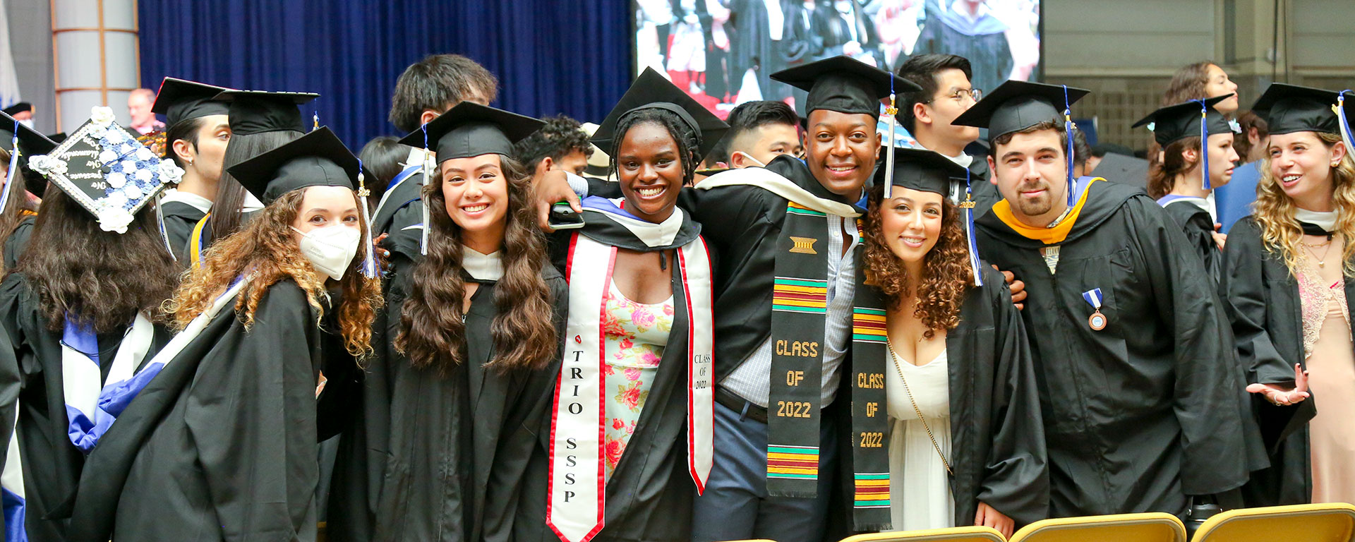 2022 Graduates in caps and gowns smile