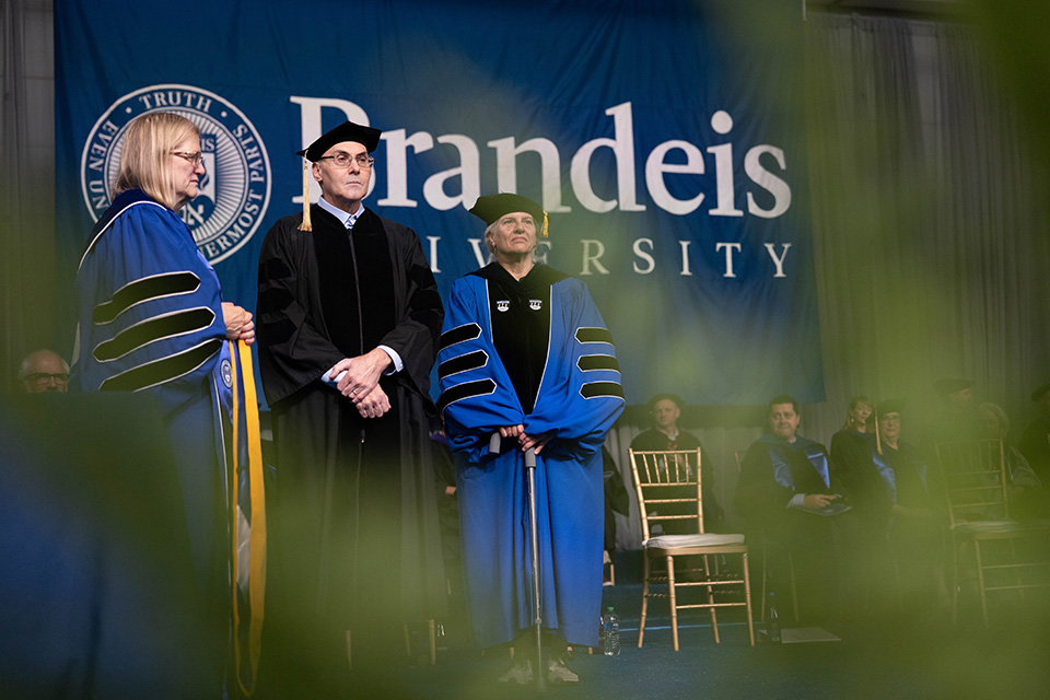 Carol Fierke, Drew Weissman, and Lizbeth Hedstrom wait as Weissman is conferred an honorary degree