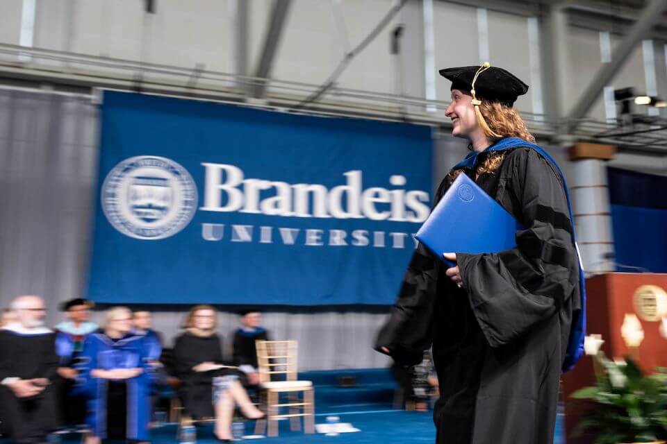 Amy Louise Scalera walks the stage after receiving her PhD in neuroscience.