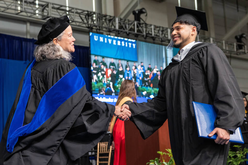 In a new addition to Commencement proceedings, students walked the stage to be greeted by Dean Dorothy Hodgson and President Liebowitz."