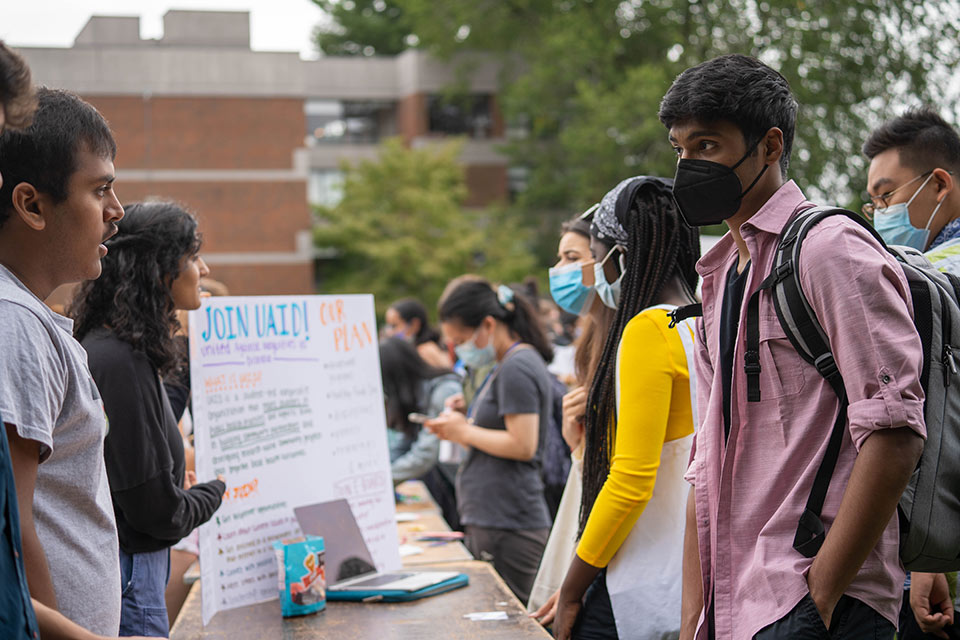 Students learning about volunteer opportunities at the involvement fair