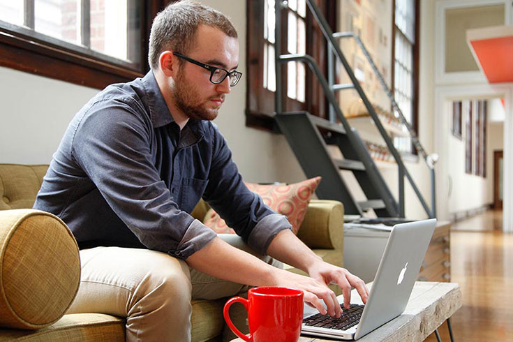 male student working on a laptop