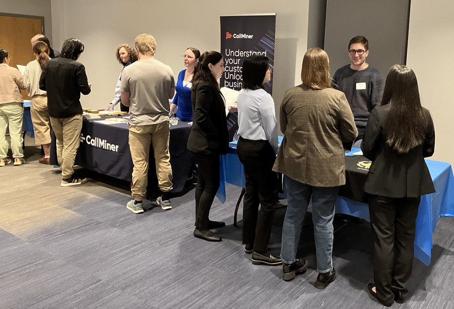 Students at industry event tables