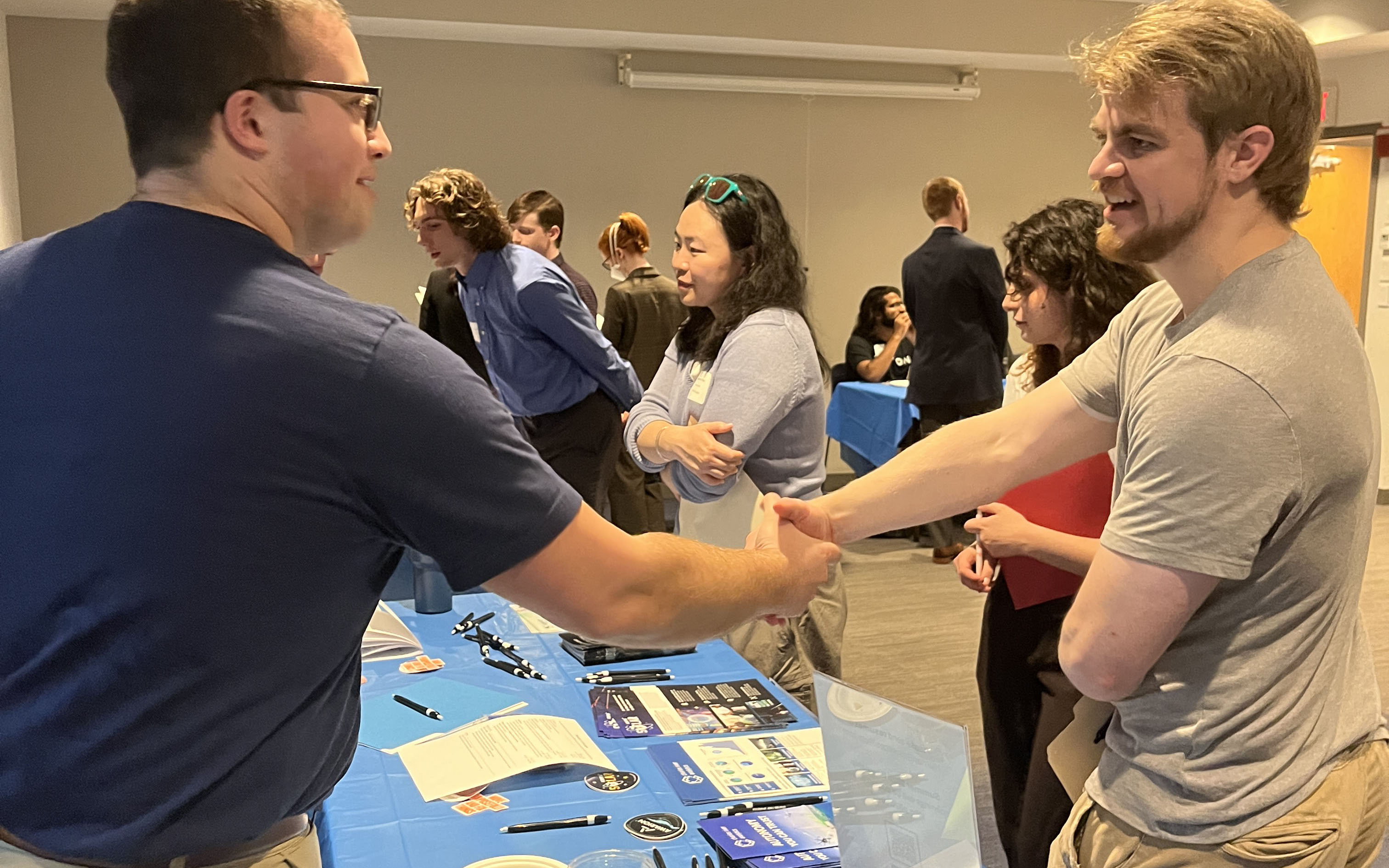 Student shaking an industry rep's hand