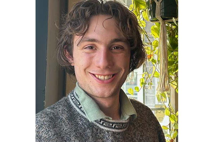 Ben smiling inside surrounded by indoor plants