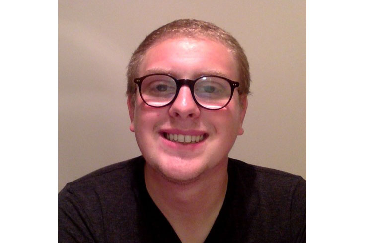 Headshot of Keelan smiling at the camera