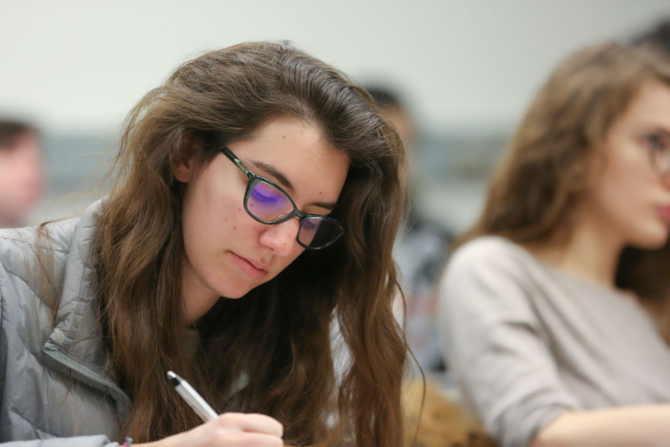 A student takes notes in class