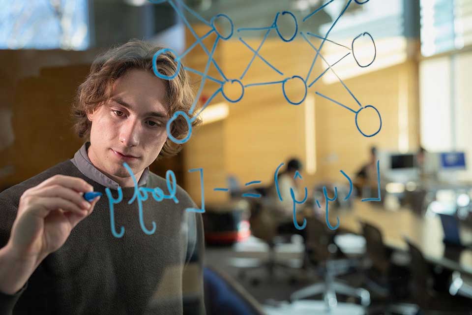 Ben Lambright draws on a clear board