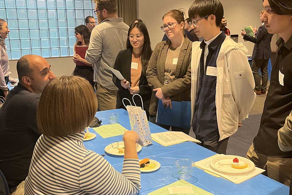 Students at industry event tables
