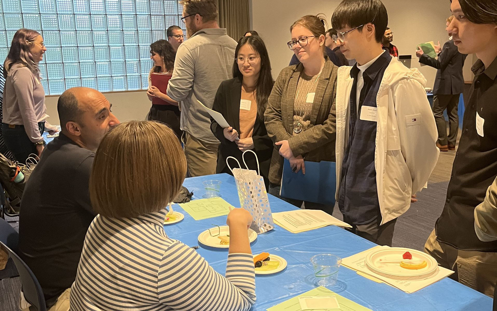 Students at industry event tables