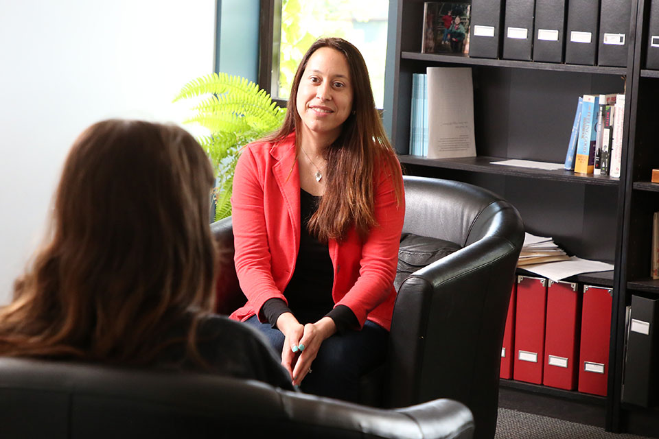 A therapist talks to a patient