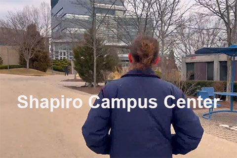 A student walking on campus with text that reads: Shapiro Campus Center (SCC)