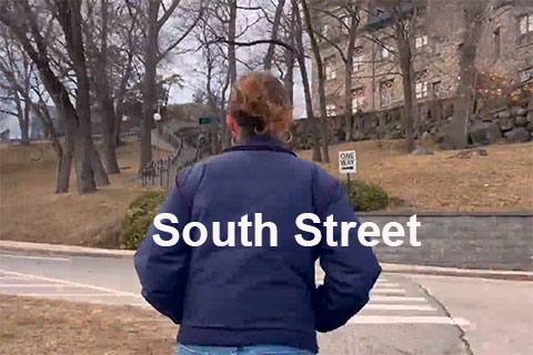 A student walking on campus with text that reads: South Street