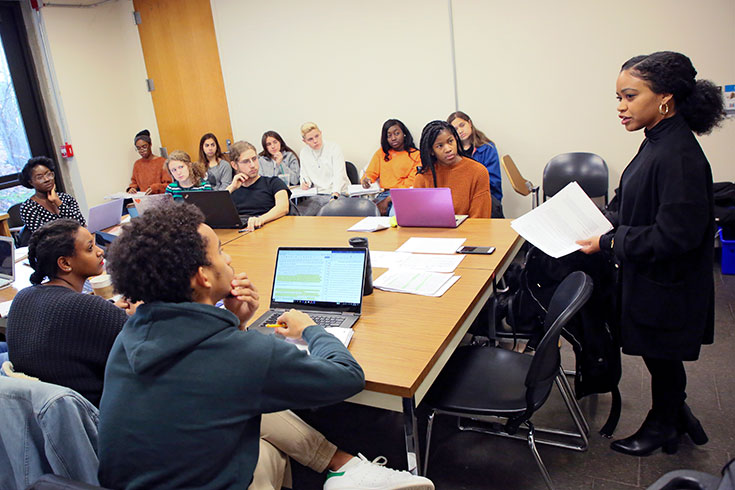 Prof. Amber Spry teaching in front of a class