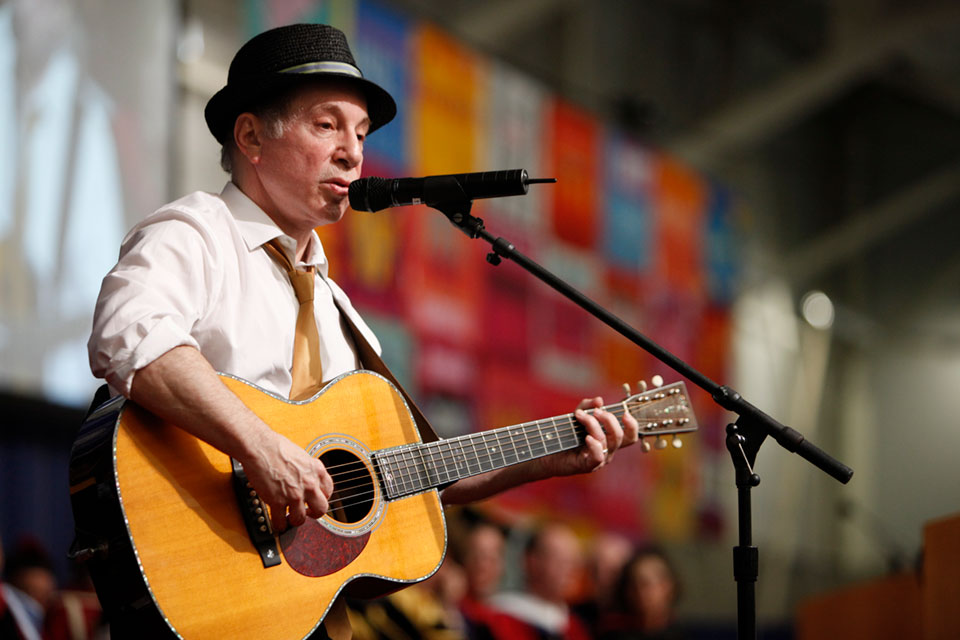 Paul Simon plays guitar