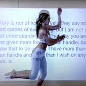 Ella Deters dancing in front of a screen with text