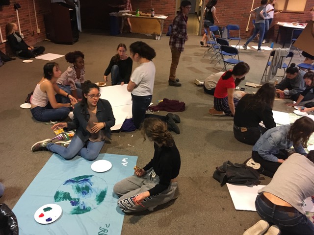 students on the floor making art