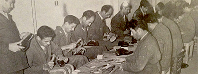 Men working at a table in prison