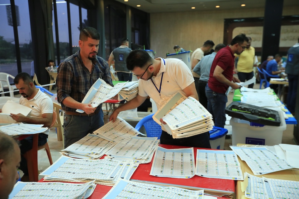Electoral commission workers count ballots in Baghdad, Iraq, in October 2021.