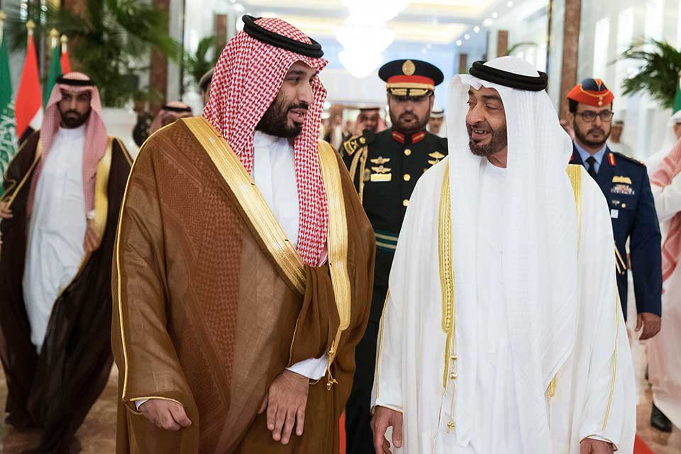 The leaders of Saudi Arabia and the United Arab Emirates walk together.