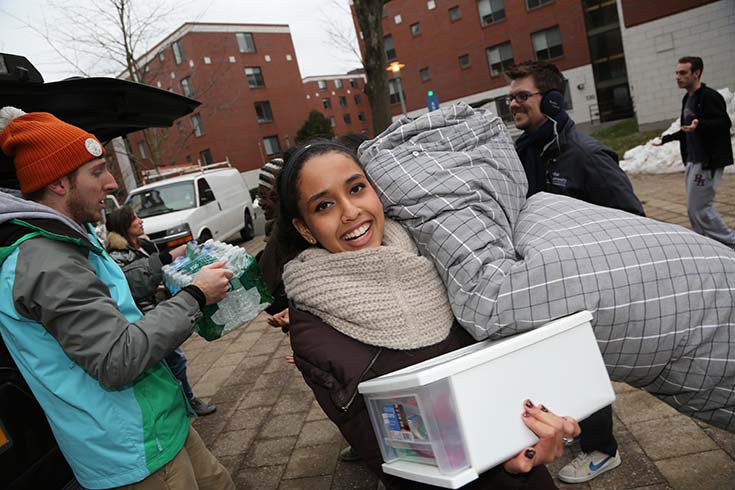 students moving into a residence hall on campus