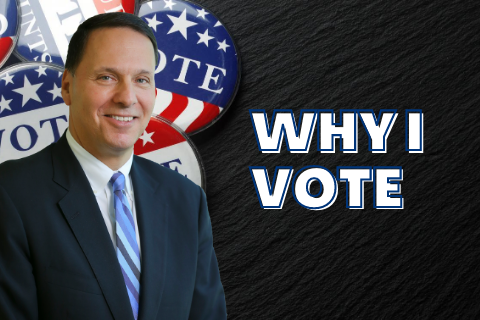 Ron Liebowitz standing next to the words Why I Vote with VOTE buttons  in the background