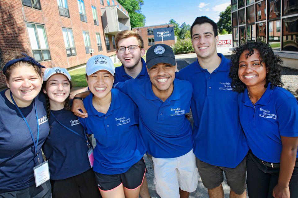 Orientation leaders and Department of Community Living student workers smiling in front of North Quad on move-in day 2018