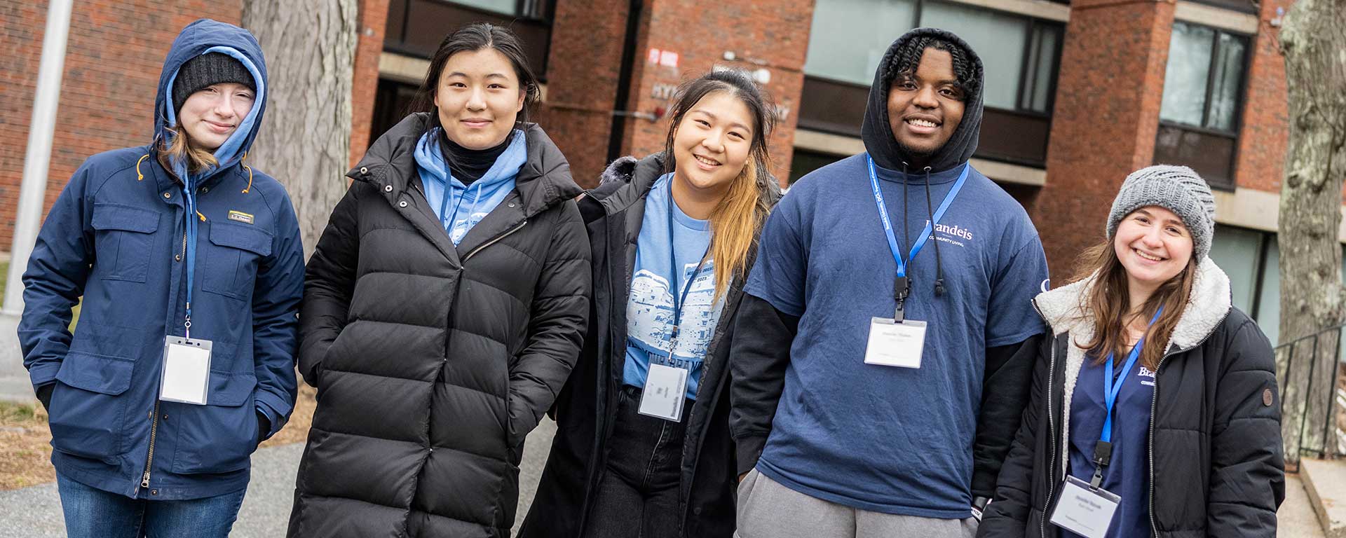 Brandeis student smile while helping with move in