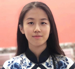 Huan Tian facing the camera, dark hair and eyes in a blue top