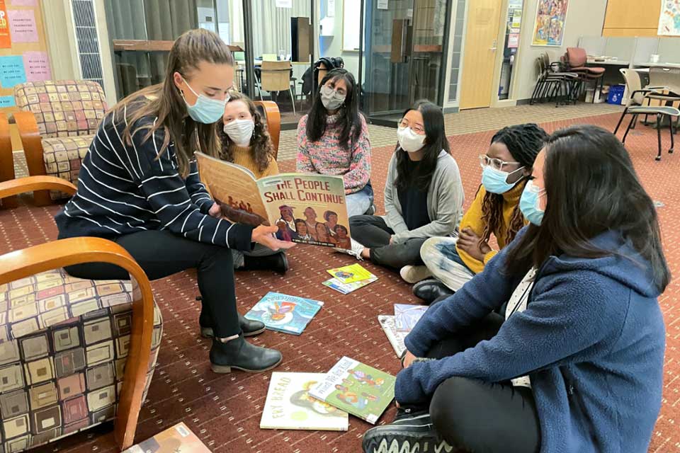 Students reading children's books.