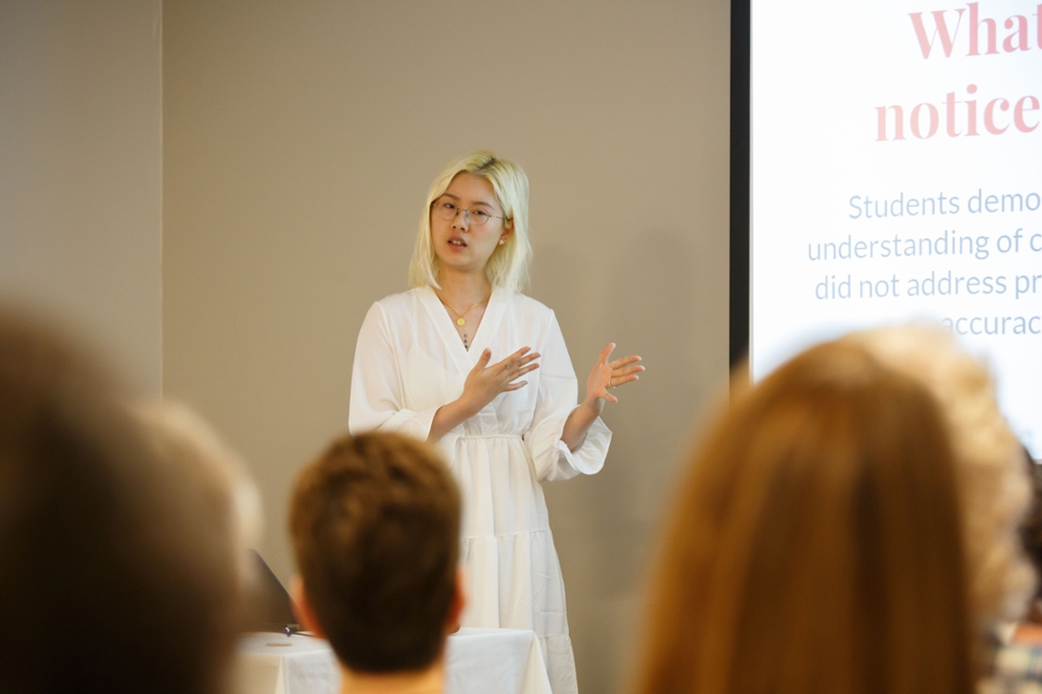 An Education program graduate student presents research in front of a group