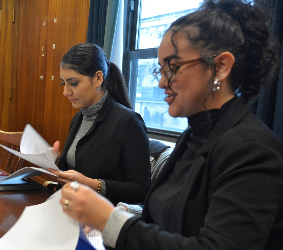 two women at a desk with papers