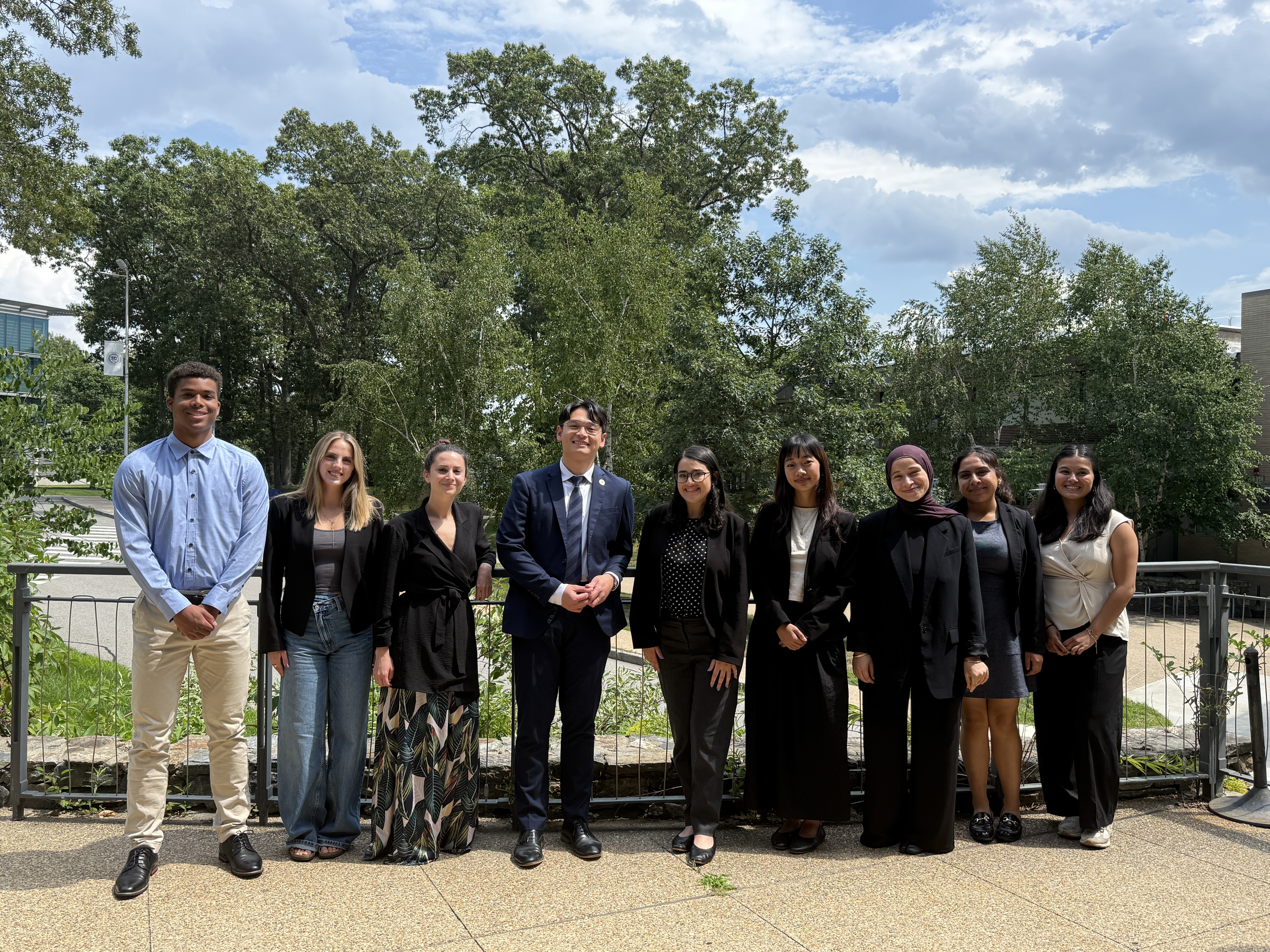 enact corps members posing outside for picture with MA representative Tara Hong