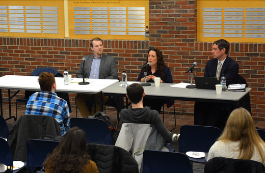 three people on a panel at Brandeis with students in the audience
