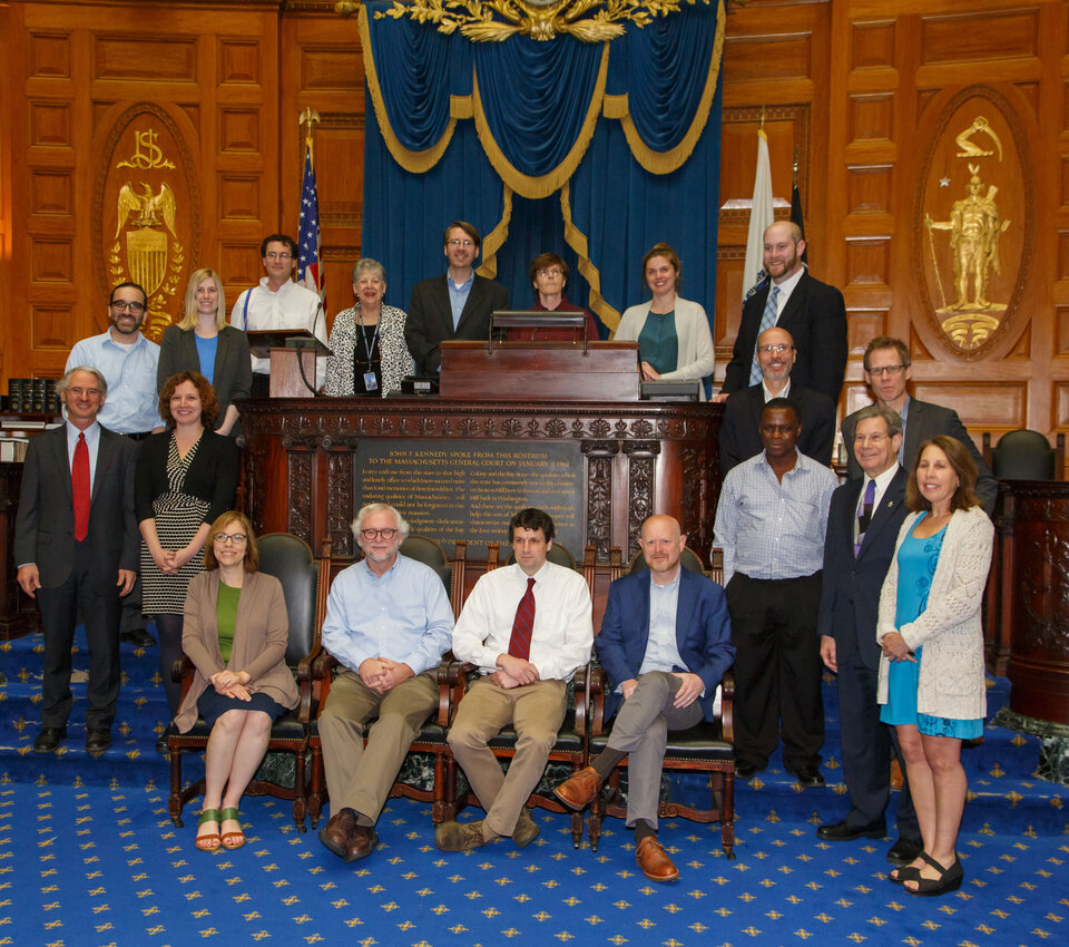 people posed around bench at chambers